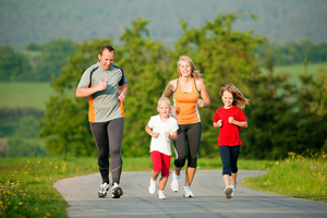 Young family jogging together on nature trail