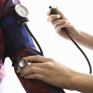 Medical provider taking a patient's blood pressure