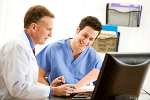 Two medical providers discussing a patient's chart