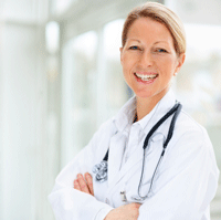 Smiling medical provider in white coat with stethoscope
