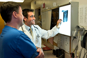 Medical provider reviewing X-ray with patient
