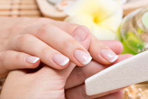 Close-up of a woman's hand and fingernails during a manicure