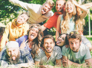 Group of happy college students clowning around on campus