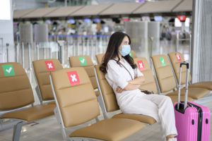 Woman wearing protective mask in international airport
