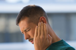 Man touching his painful ear
