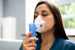 Woman with COPD using rescue inhaler