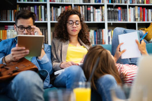 Group of college students studying in library