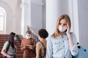 Female college student wearing mask on campus
