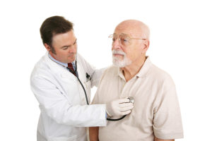 Doctor listening to a senior patient's heartbeat. Isolated on white.